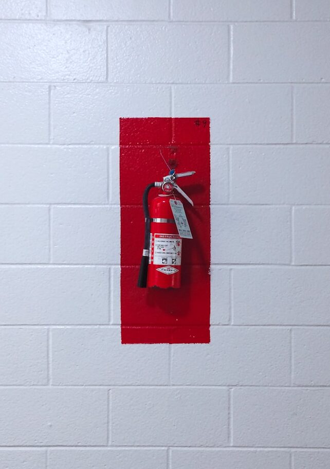 red fire extinguisher on wall